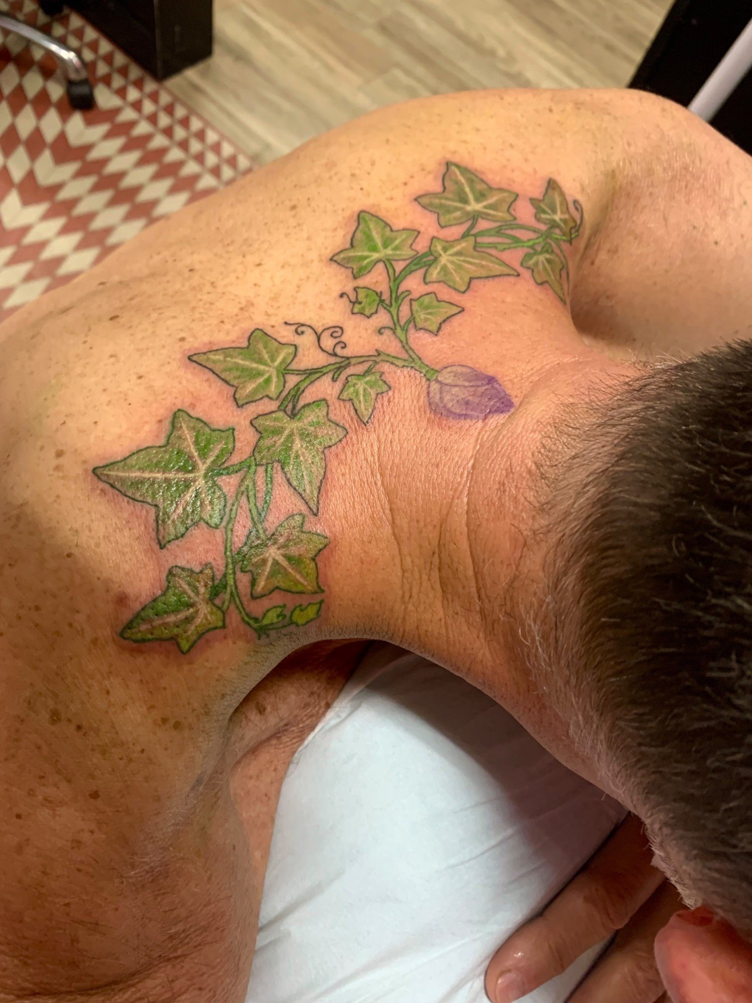 Ivy vine tattoo across the shoulder